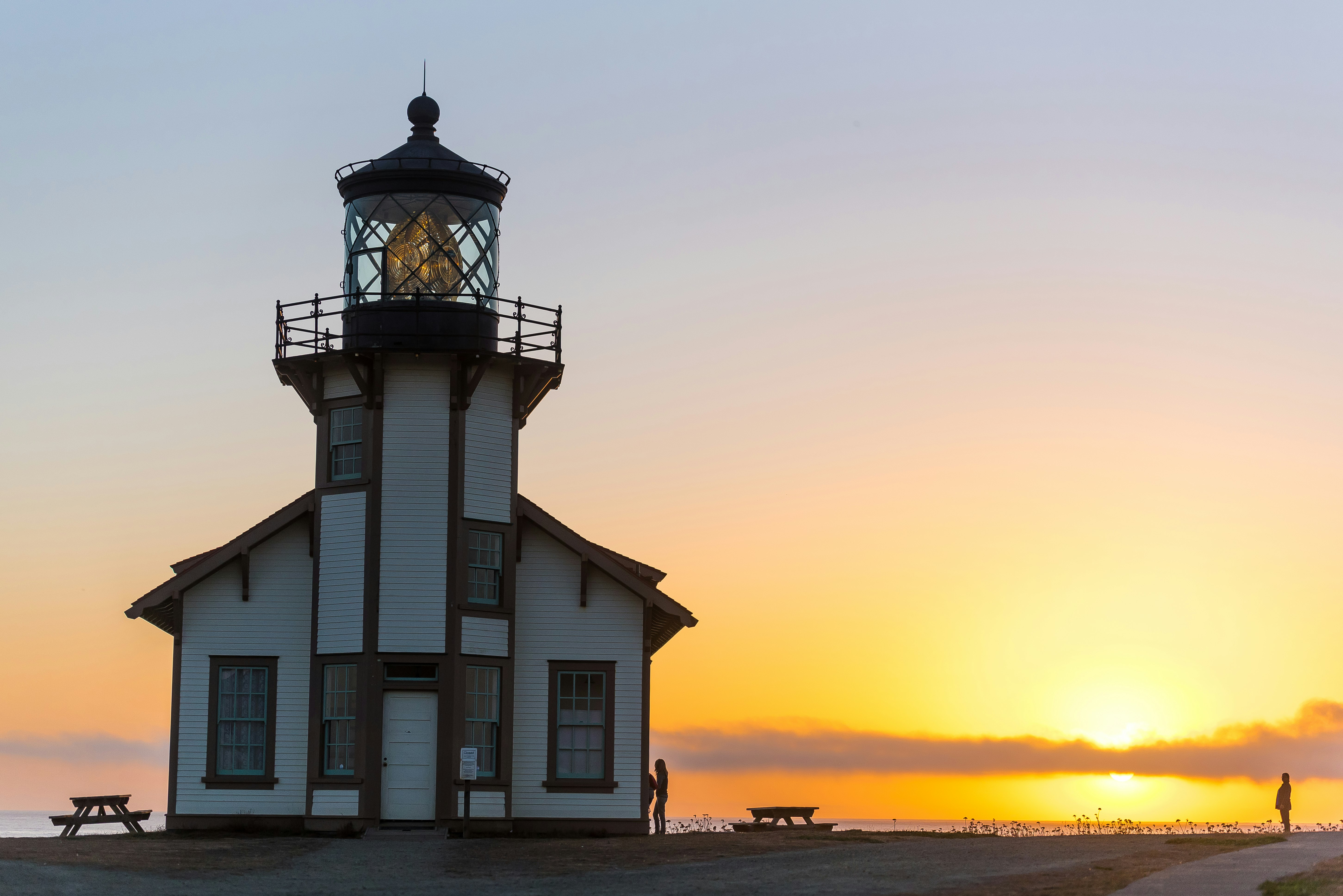 white and brown lighthouse tower view during sunset